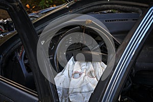 Look inside a silver passenger wrecked car with airbag deployed.