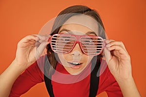 Look with interest. Eyewear fashion shop. Party accessory. Having fun. Carnival party. Kid and striped eyeglasses. Girl