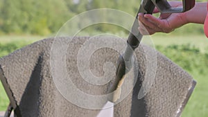 The look of the lady cleaning the doormat . A pressure washer in a person hand.