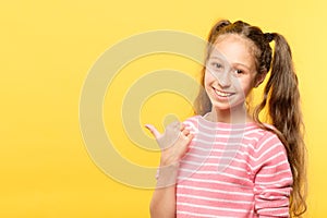 Look left smiling girl point thumb virtual object