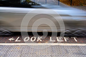 Look Left warning at a pedestrian zebra crossing in the streets of London, England