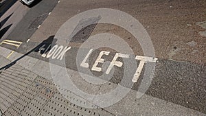 Look left words on pavement in London Oxford Street