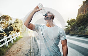 Look in the mirror. Thats your competition. a sporty young man drinking water while exercising outdoors.