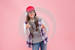 look at that. new technology. unhappy teen girl in cap and headphones. kid casual fashion style.