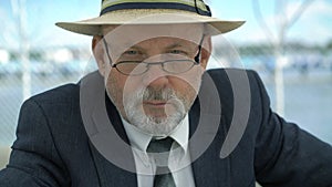 Look of old man in hat and glasses head up and looking on camera. 4K