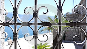 Look Through Ornate Old Window Bars On A Promenade By The Sea