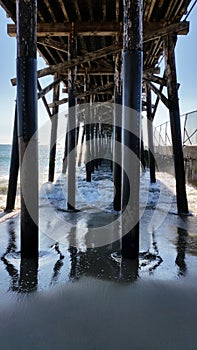 Look out into ocean under pier at the beach