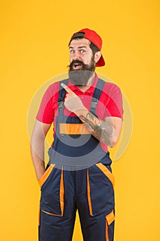 Look over here. professional delivery loader service. confident in uniform. working on construction site. bearded male