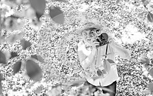 Look over there. male photographer enjoy cherry blossom. travel and walking in cherry park. hobby at retirement. tourism