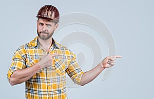 look over there. mature builder in shirt. unshaven man on construction site. handsome building worker in hard hat. labor