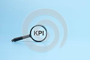 look at the text KPI through a magnifying glass on a blue background