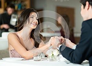 Look into their eyes, thats where love is. a happy young couple enjoying a romantic date at a restaurant.