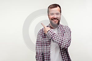 Look there! Portrait of positive happy bearded man pointing finger to the side up,. white background