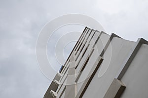 Look up at apartment housing in Thailand. Step of building.