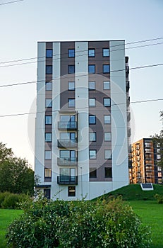 Look up to the white new building in Lasnamae part of the city with green grass. Tallinn, Estonia. September 2023