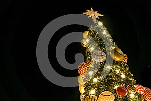 Look up view of Christmas tree and decorate with led lighting isolate on black background