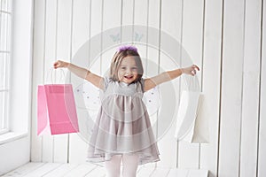 Look what I have. Beautiful little girl with fairy costume having fun posing for the pictures