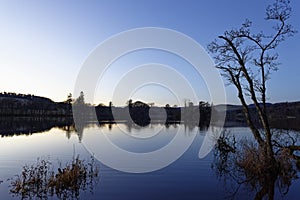 Looking across the calm waters of Clunie Loch in Blairgowrie at Dusk.