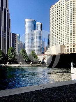 Looking across the Chicago River at the numerous tall sky rise buildings.