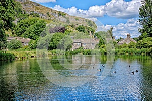 Looking across a lake, towards Kilnsey Crag, Wharfedale, Yorkshire.