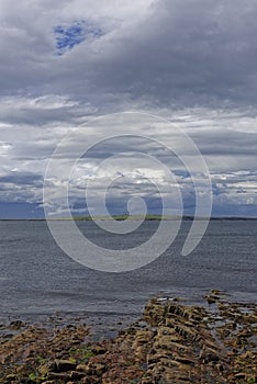 Looking across to the the island of Stroma, part of the Orkneys from the rocky beach at John OÃ¢â¬â¢Groats.