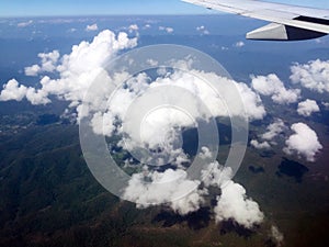 Looking aerial view of Cloud and Green Mountain outside Airplane Window photo
