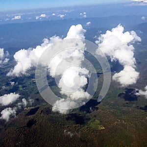 Looking aerial view of Cloud and Green Mountain outside Airplane Window photo