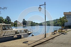 Looking along the tranquil River Lot at Port de Penne, the old river port for Penne d`Agenaise