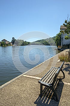 Looking along the tranquil River Lot at Port de Penne, the old river port for Penne d`Agenaise