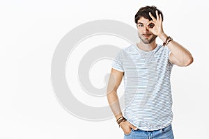 Looking on bright side is ok. Portrait of good-looking relaxed and friendly young masculine male with beard and blue