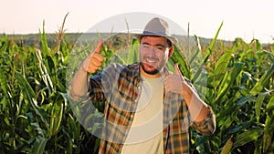 looking at camera, wink, young man in field shows gesture thump up, ok, dancing, say wow.