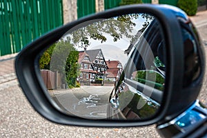 Looking through the car mirror to the streets of Seebach