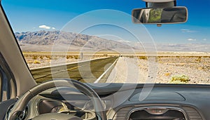 Car windshield with view of desert road, Death Valley, USA