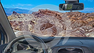 Car windshield view of Zabriskie Point, Death Valley, California