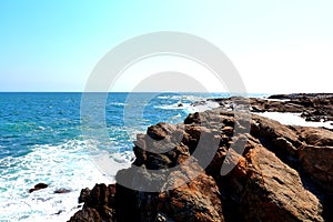 Looking from the Cliffs with waves rolling onto the shore in Rhode Island