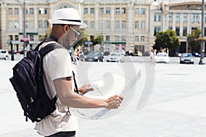 Looking for directions. Lost tourist looking at city map