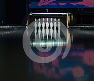 Looking down a bowling lane, waiting for the ball to hit