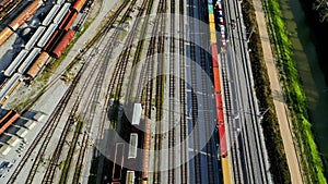 Looking down at cargo trains standing still, not moving, parked at the station