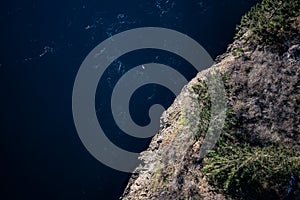 Looking down from Deception Pass bridge at rocks and water