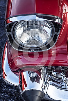 Looking down front chrome headlight and bumper 1957 chevy Bel air classic muscle car photo