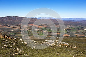 Looking down on green farm land from the Swartberg Pass