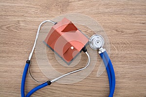 Looking down a house model with a stethoscope on the table
