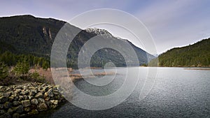 View of a distant mountain from the lakeshore. photo