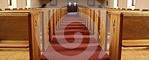Aisle of traditional Christian church with empty pews photo