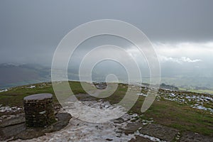 Looking down from Lose Hill, over the trig point at its peak, in the Hope Valley, Peak District, Derbyshire