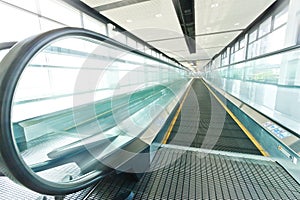 Looking down at multiple escalators in an office building or mall..