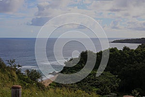 Looking down onto Kaluakai Beach and the Pacific Ocean surrounded by rainforests in Kauai