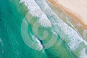 Looking down at paddler boarders in the surf