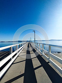 Looking down the pier to the sea