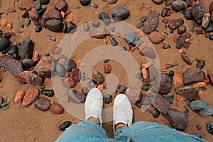 Looking down at sand and rocks in Legzira Beach. Rugged coastline in the Tiznit Province of Morocco, Africa. Perspective shot.